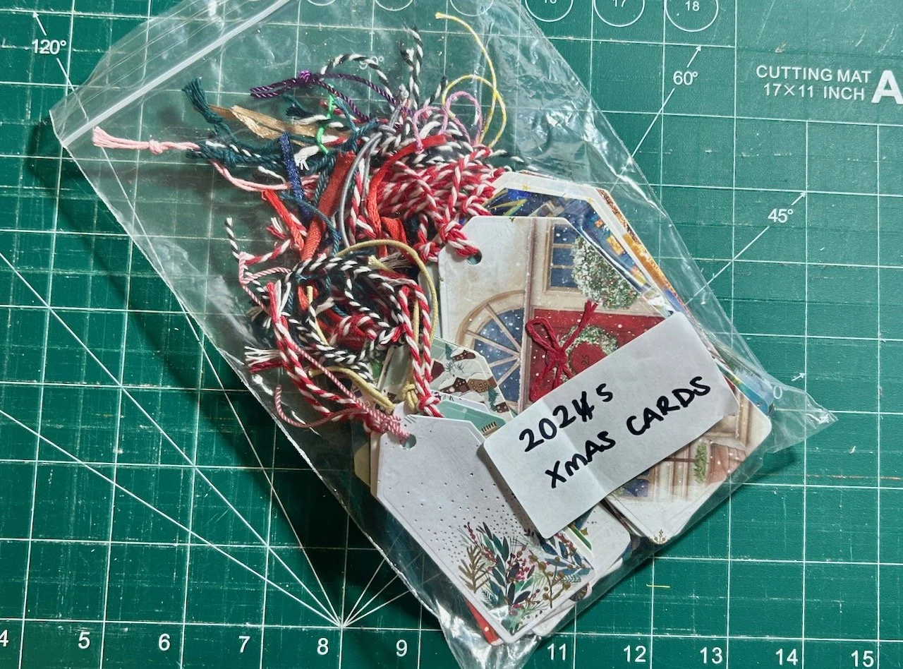 The completed tags stored in a plastic bag - which is also being reused!