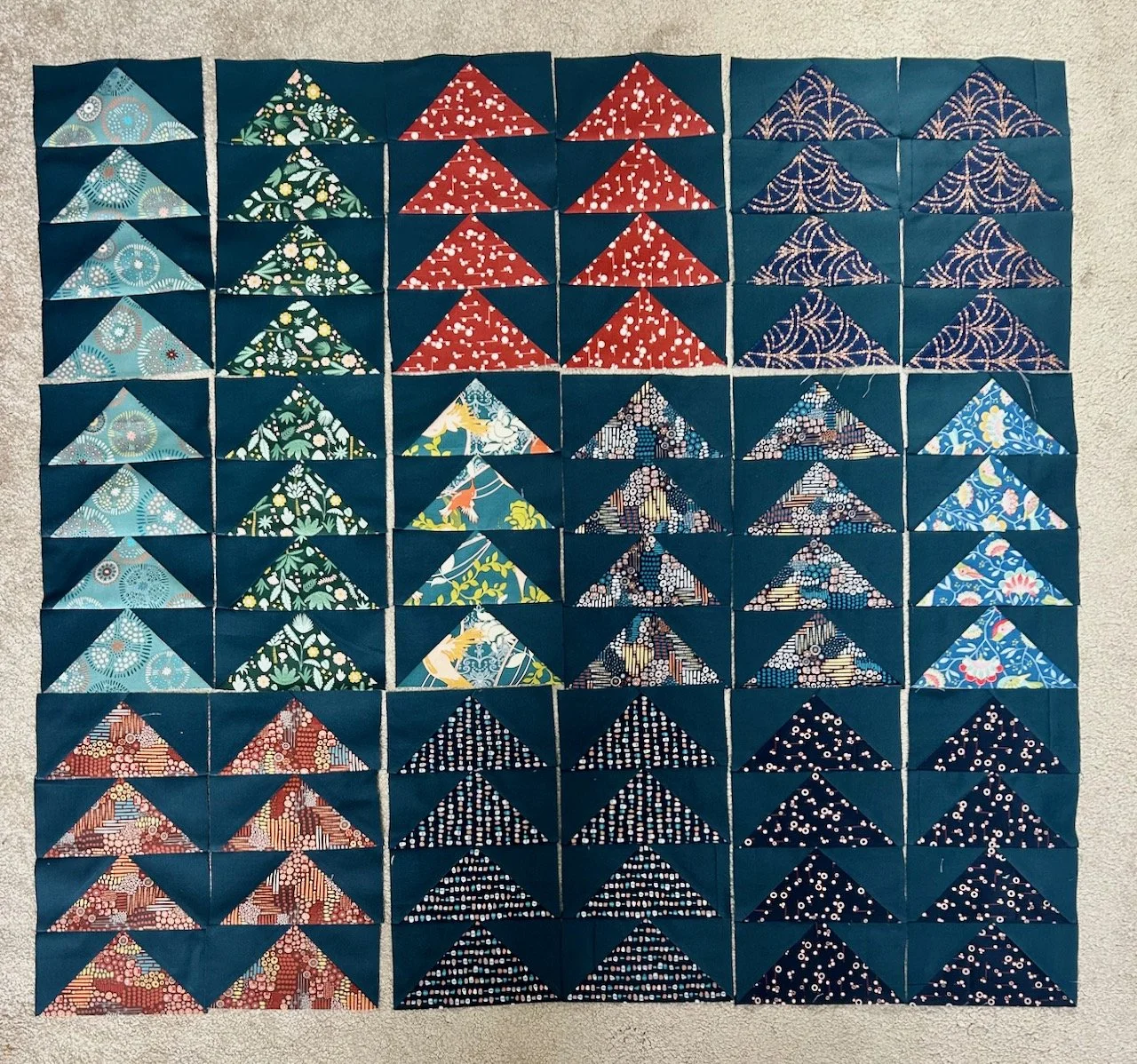 Laying out the completed flying geese blocks to see where I'm at