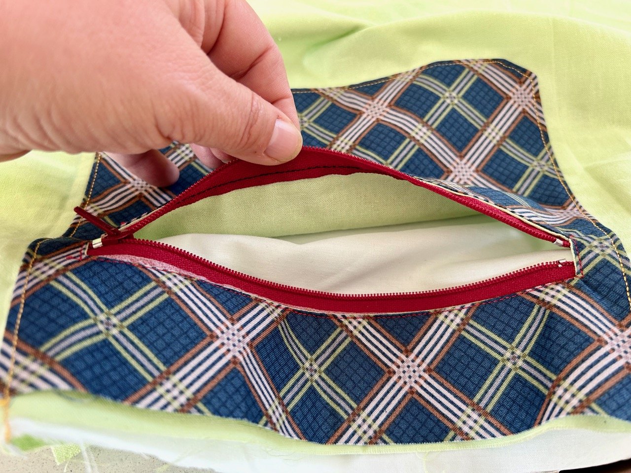 Peeking inside the blue criss cross pocket to the tweaked fix and plain linings