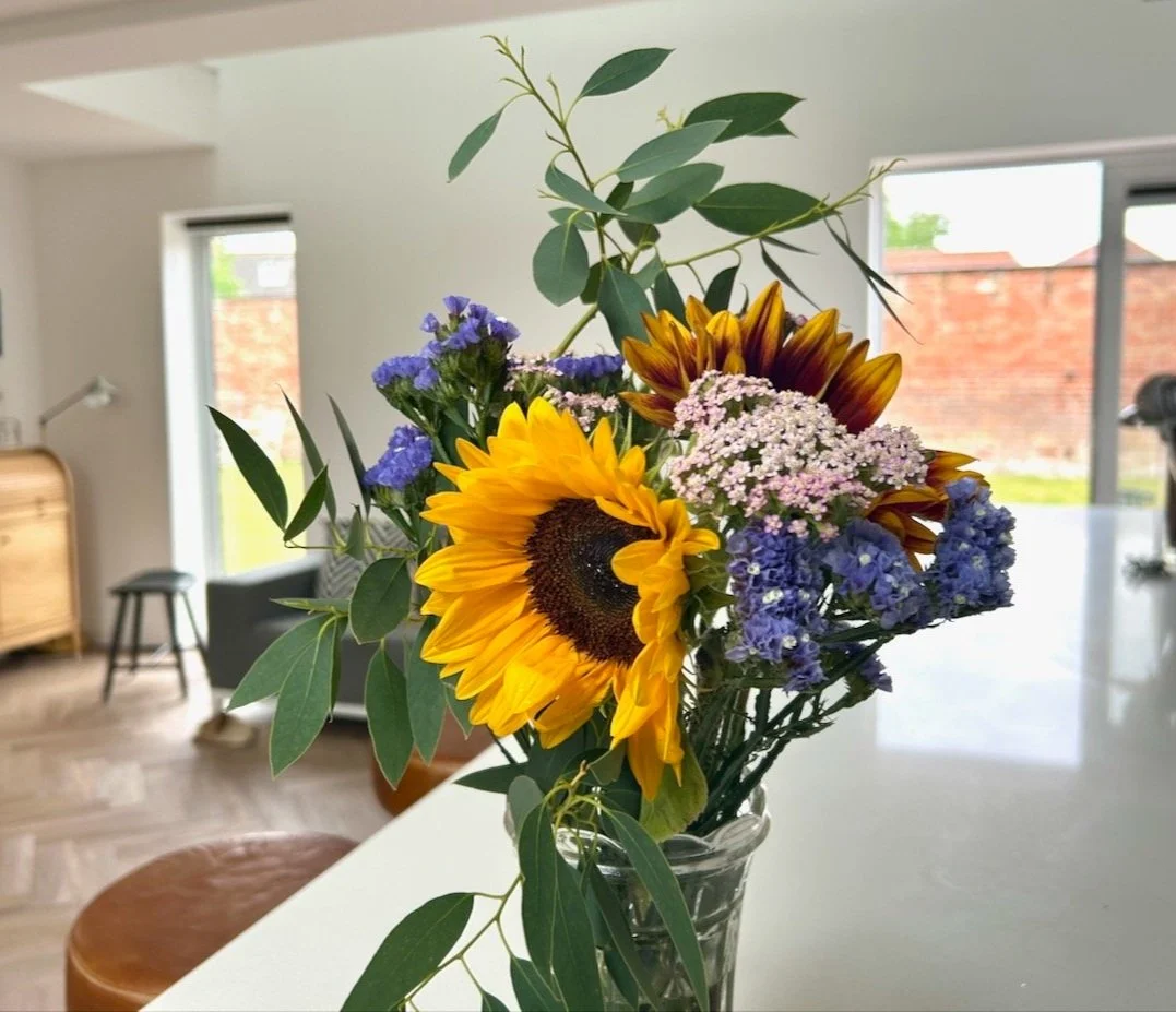 A small bouquet with sunflowers in a vase in my kitchen