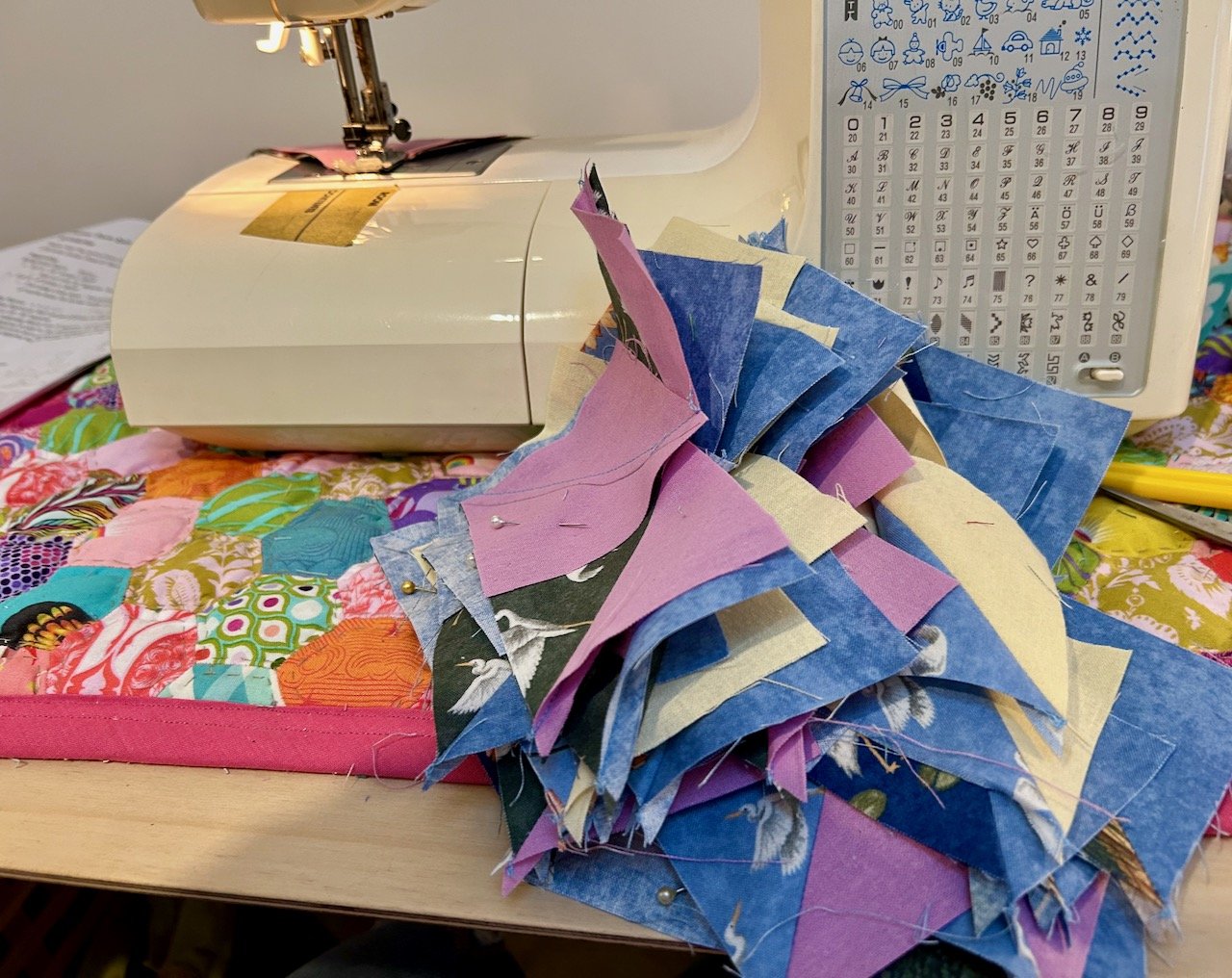 a flock of flying geese sewn using the chain method part-way through construction in front  of my sewing machine