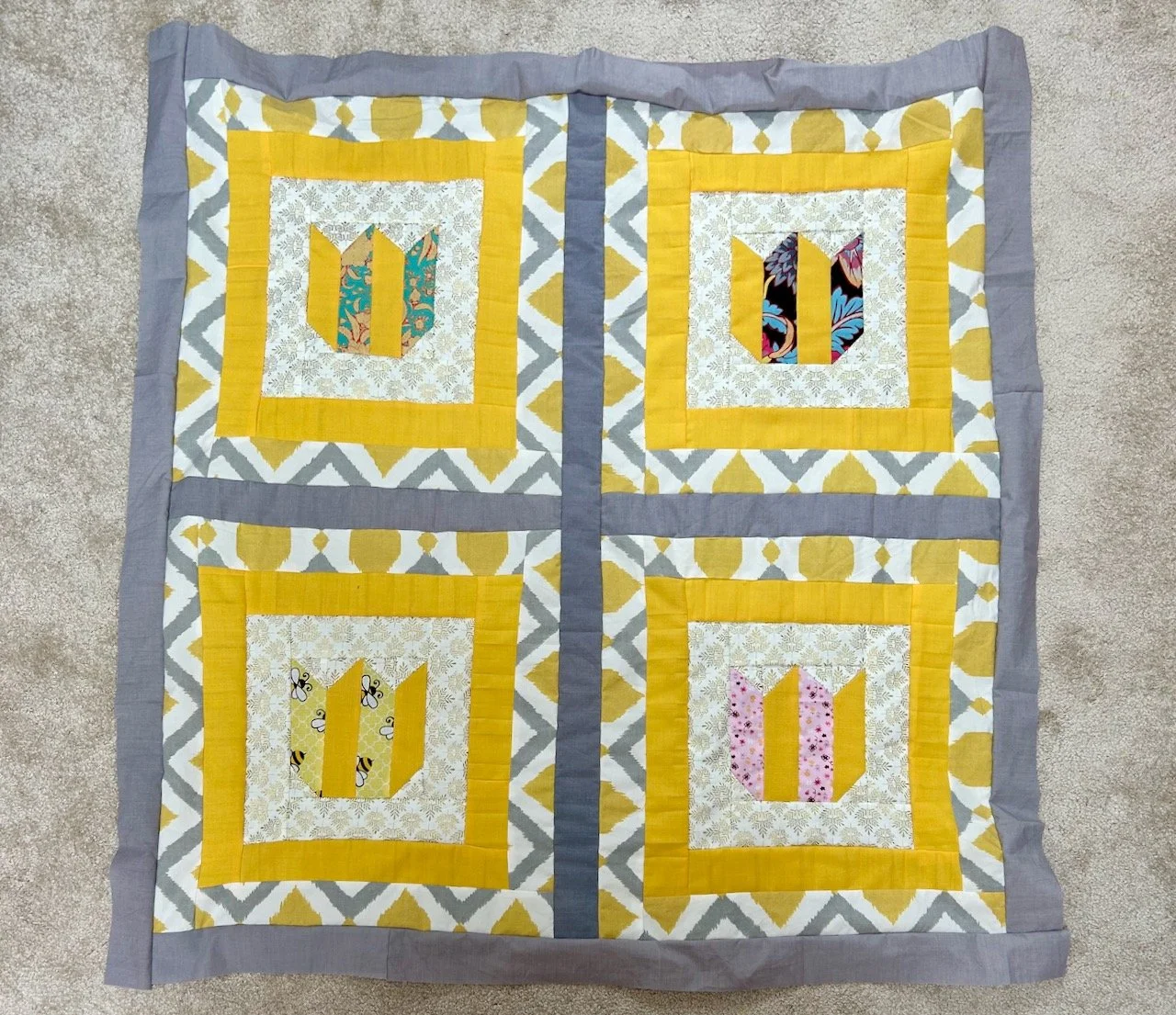 The grey sashing sewn in place, and a border added around the whole quilt top using the same material