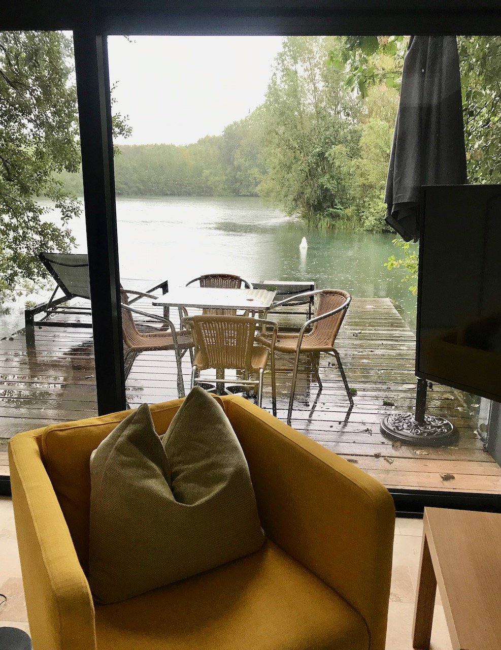 Looking over the deck on the lake to the swan diving for food