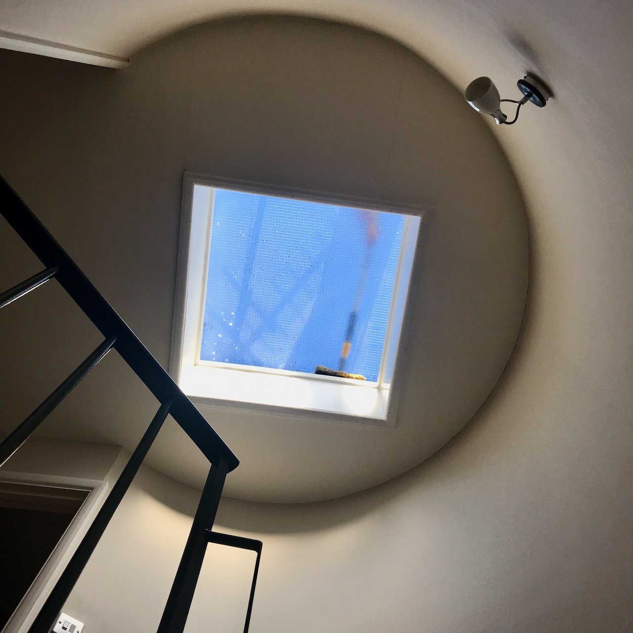 Looking up to the skylight above our spiral staircase - while it's being cleaned