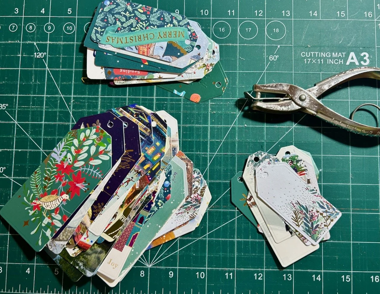 Those same tags with holes punched, and my vintage ticket clipper is shown top right