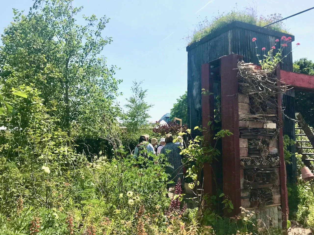 on the right another tall structure in the garden which is also a very large bug hotel