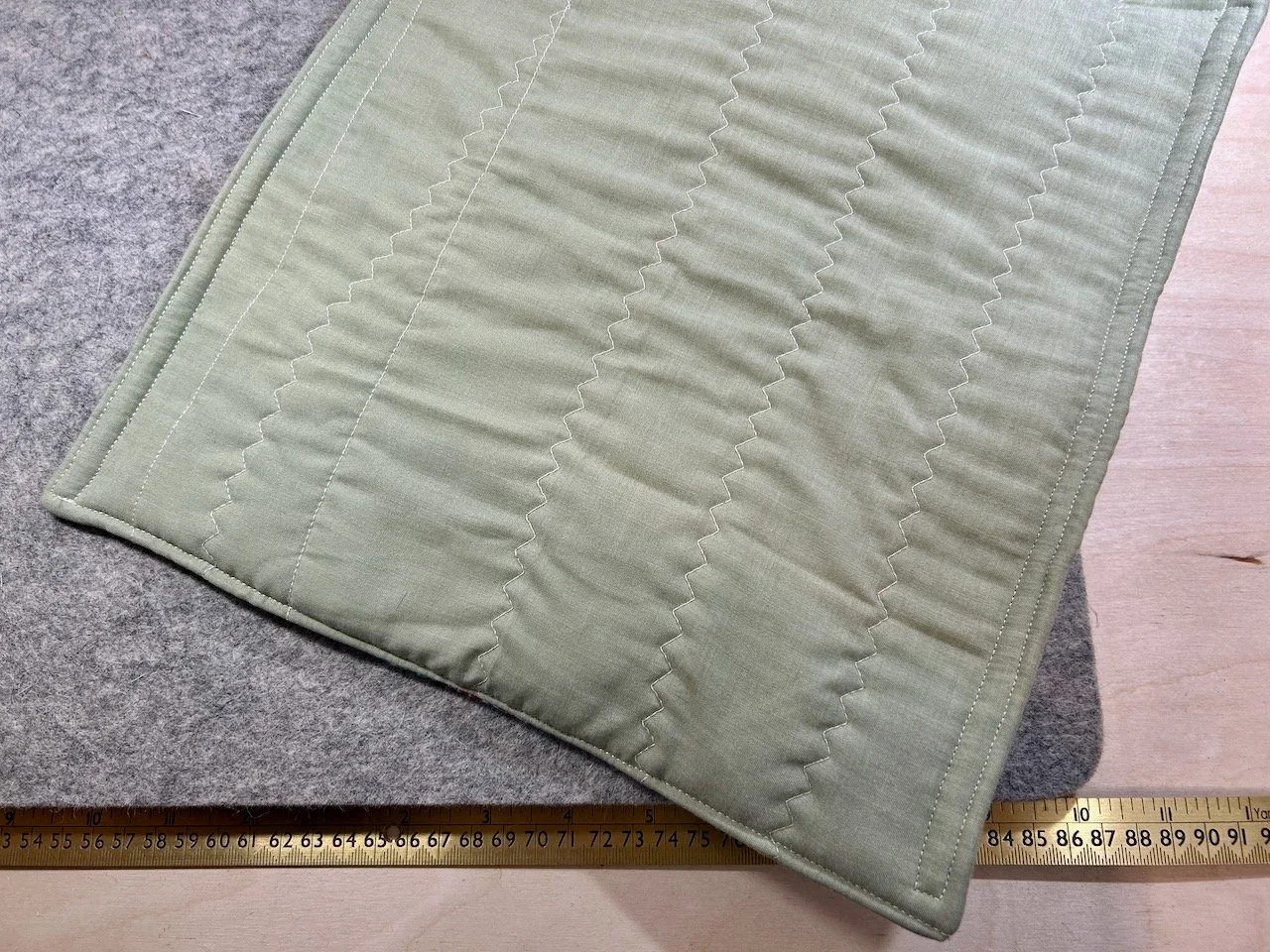 The pale green back quilted with offcuts of wadding - hence some of the more wavier lines