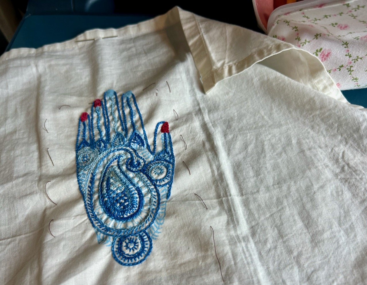 My holiday embroidery - a very elaborate and decorated hand, stitched in various blue threads