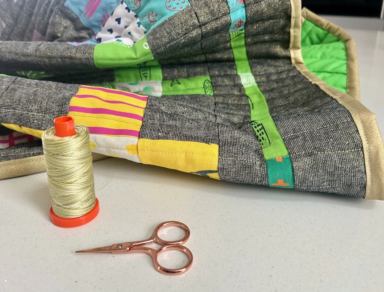 Finishing the gold binding with a variegated Aurifil thread