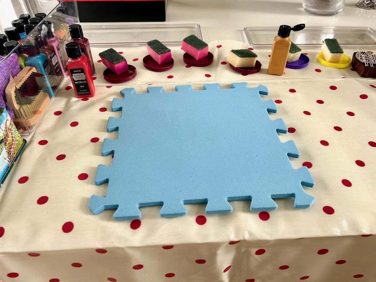 All set for block printing - a pvc dotted sheet to cover the worktop, paints and a foam board