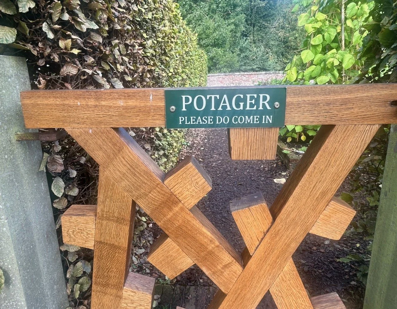 Stepping through the Potager gate which contains the work Yat - Yorkshire dialect for gate