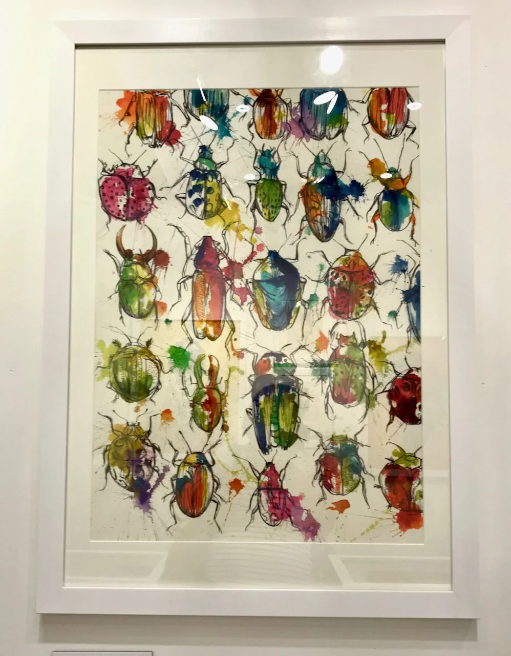 a larger painting of bugs in a grid format five abreast and five deep, the colours painted on are jewel like - and are in places painted outside of the lines