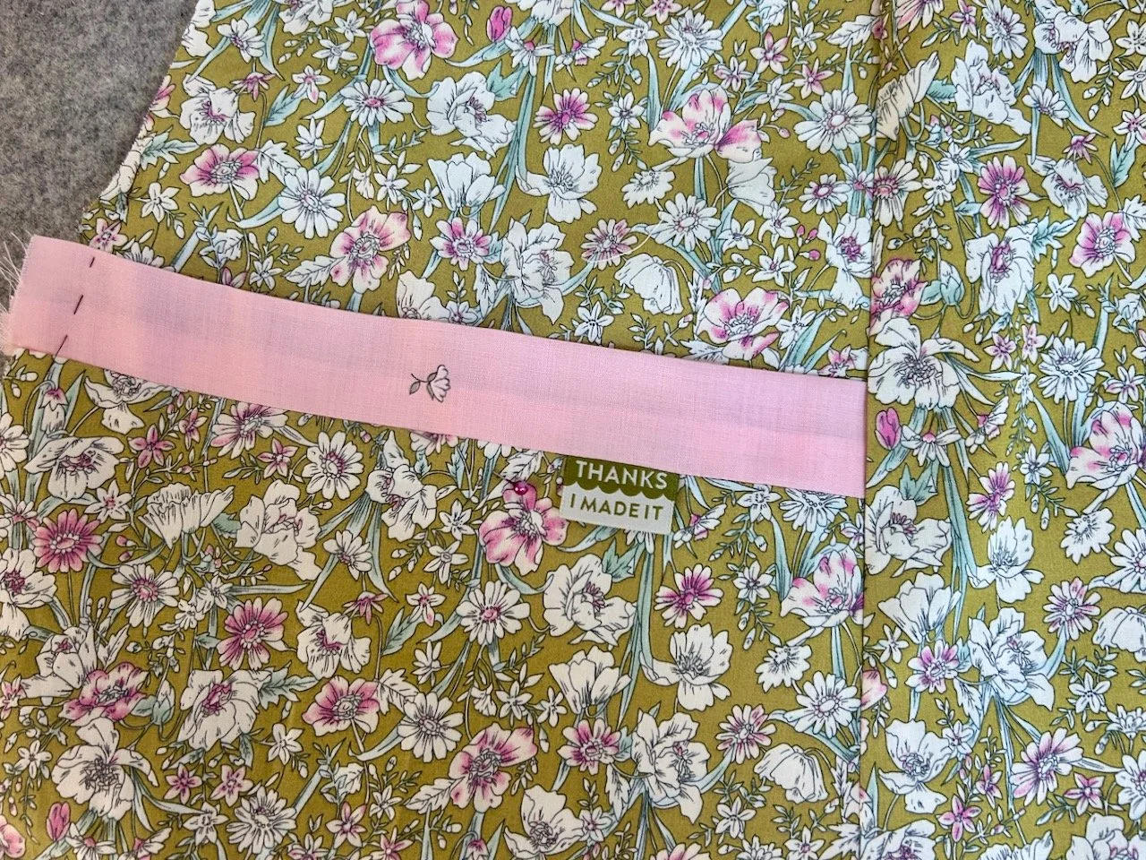 The pocket with pink trim and toning 'thanks I made it' label
