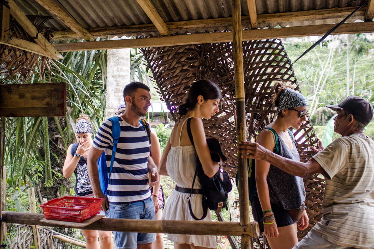 With his limited English, Wayan Runia tried to ask the donation from the tourists.
