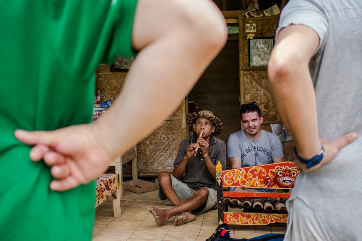 Wayan Kantun attracts the tourist with his balinese music ensemble while he sell snacks and young coconut.