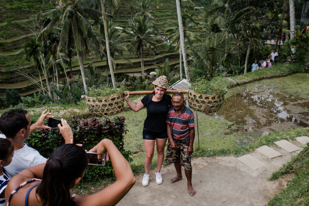 The tourist took a self portrait with the farmer.