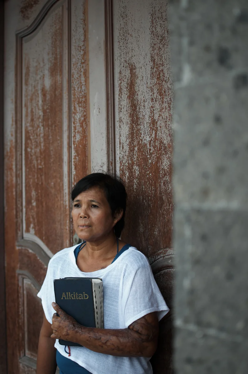 Yayuk on July 2, 2012 posing with a Bible. She converted to Christianity from Islam after the bombing