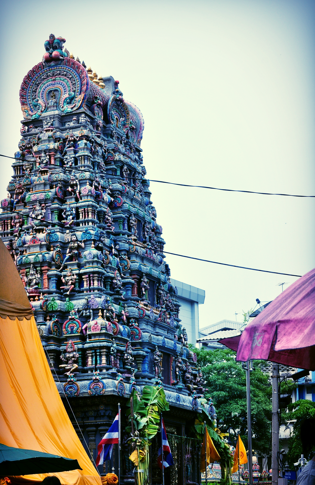 The Hindu Temple or "Wat Kaek" is situated in front of "Thanon Pan" if you enter from Silom Road.