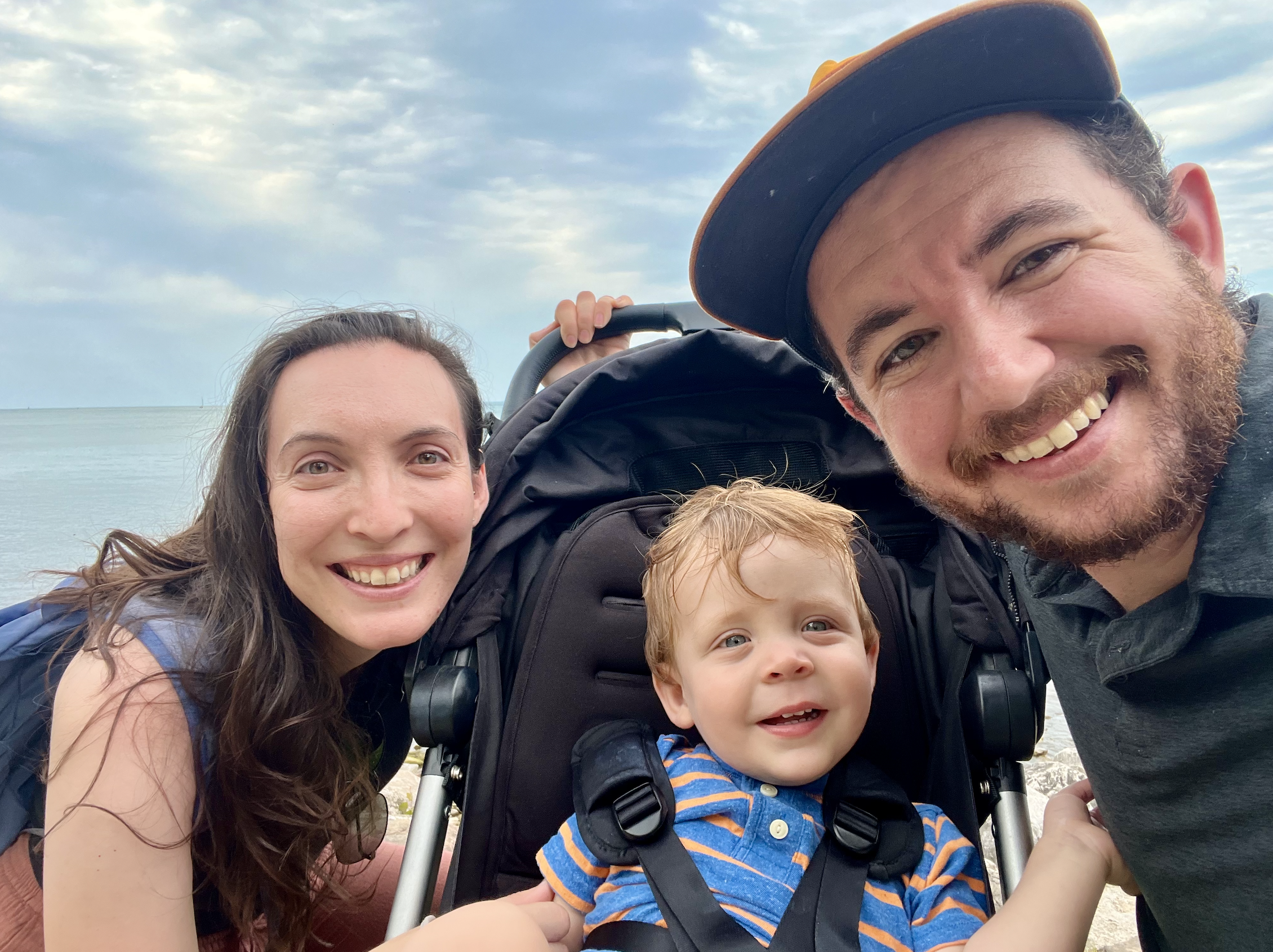 Sarah, Eli, and Graham smile for the camera in front of Lake Ontario.