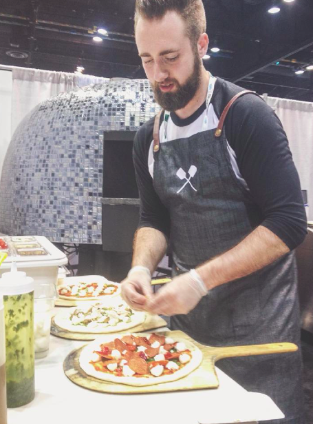 Jonathan Cowan making pizzas at the Marra Forni booth at the 2015 National Restaurant Association show in Chicago, IL.