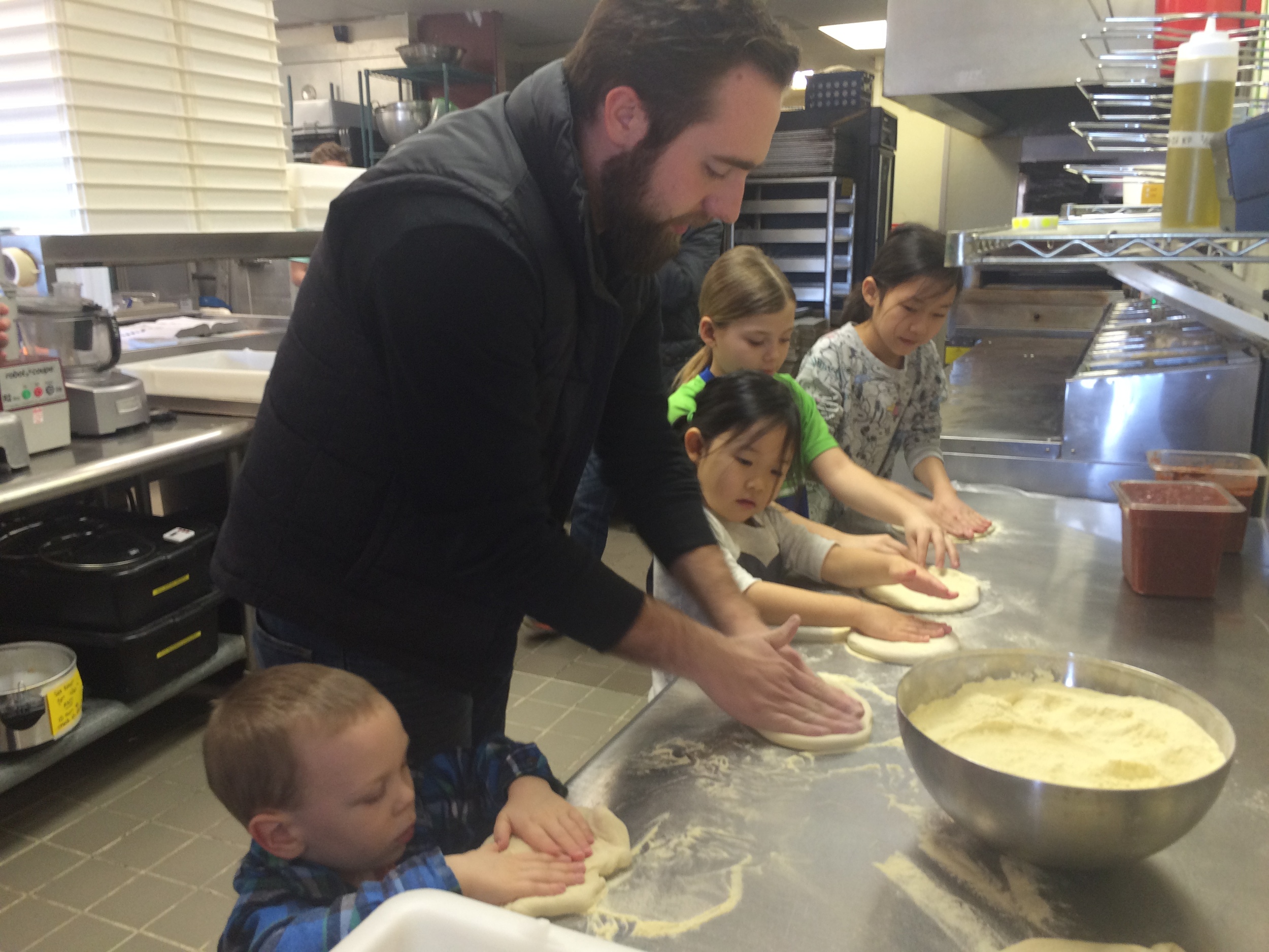 Jonathan Cowan teaching pizza making to all the winners of the Orland Park Prairie's annual Valentine's Day coloring contest at Wooden Paddle Pizza.