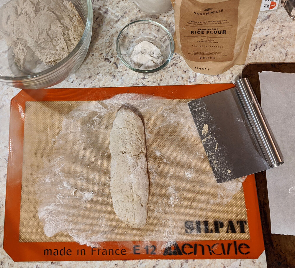 Dough patted into a baguette