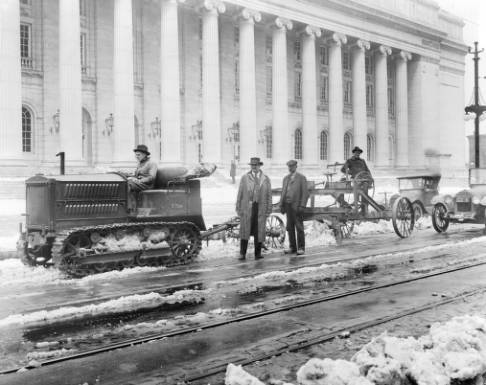 Tractor_and_blade_cleaning_snow_from_streets_near_Post_Office.jpg