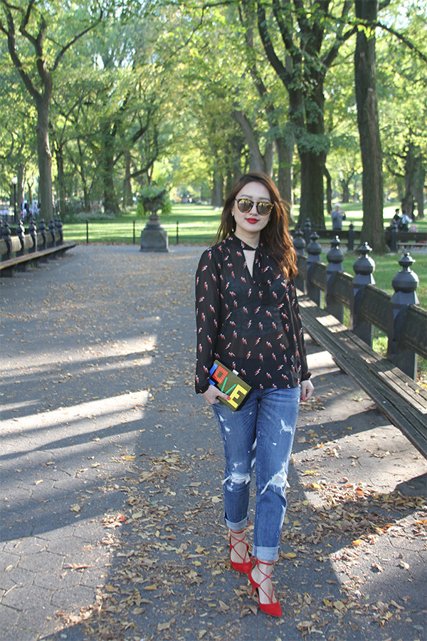 bethesda fountain, central park, new york, nyc, fashion blogger, street fashion, junelemongirl, june lemon girl, black leather jacket, red lace up heels, red heels, kitten heels, love clutch, distressed jeans, printed chiffon blouse, v neck blouse, tie neck blouse, red lips, mirrored sunglasses, autumn fashion, autumn style