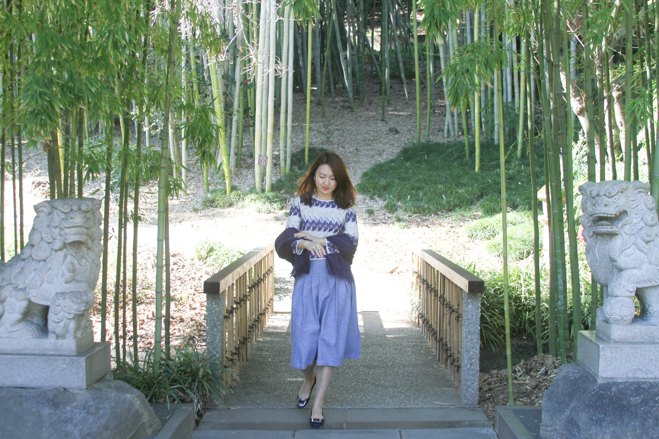 junelemongirl, botanic garden, spring outfit, street style, spring style, embroidered top, blue skirt, pleated skirt, wool skirt, midi skirt, street fashion, fashion blogger, new york fashion blogger, LA blogger, buckle flats, blue tote, saint laurent tote, sac de jour tote, prada flats, bamboo forest, lion sculpture, girl