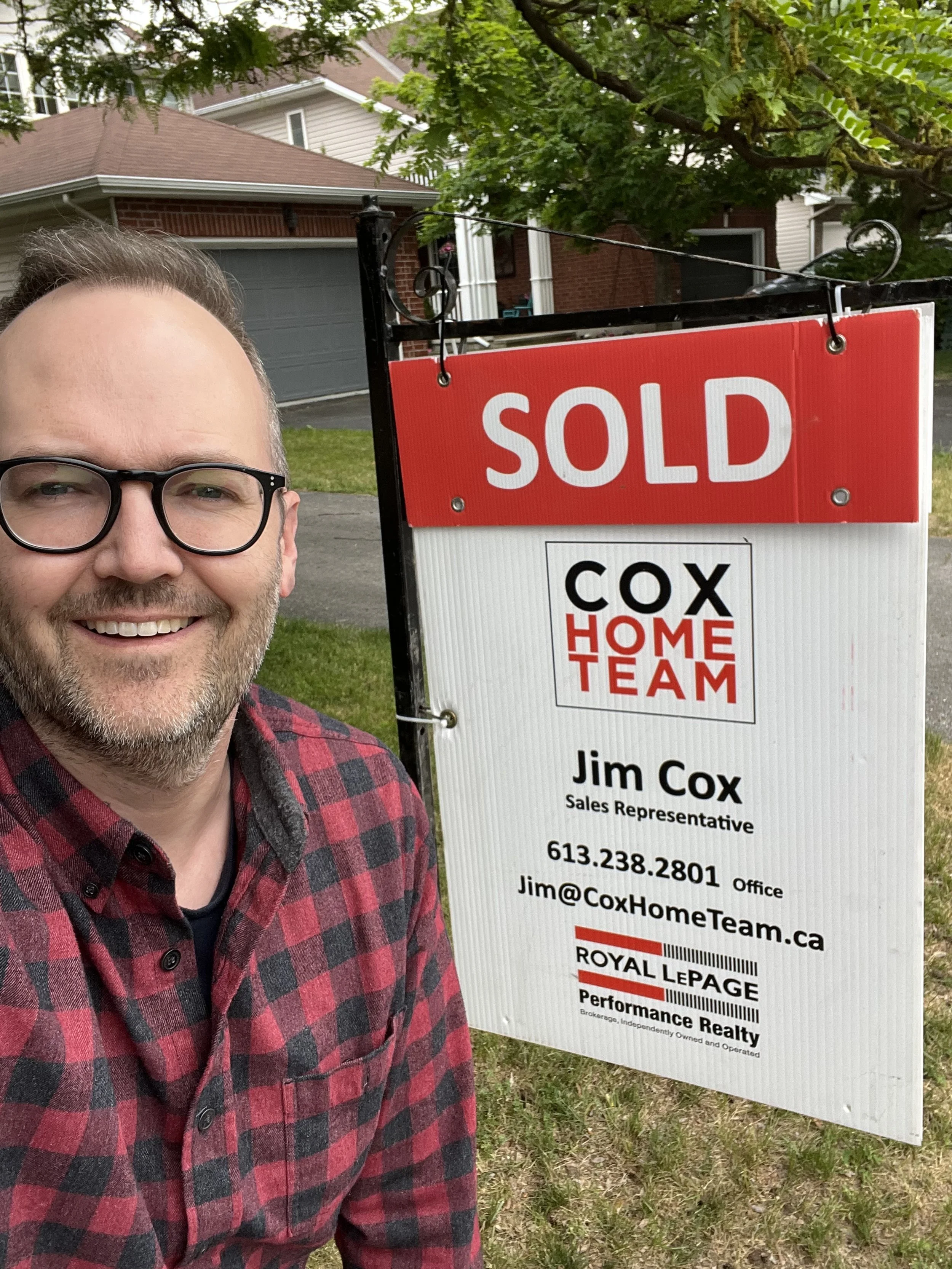 Jimmy with sold sign.jpg