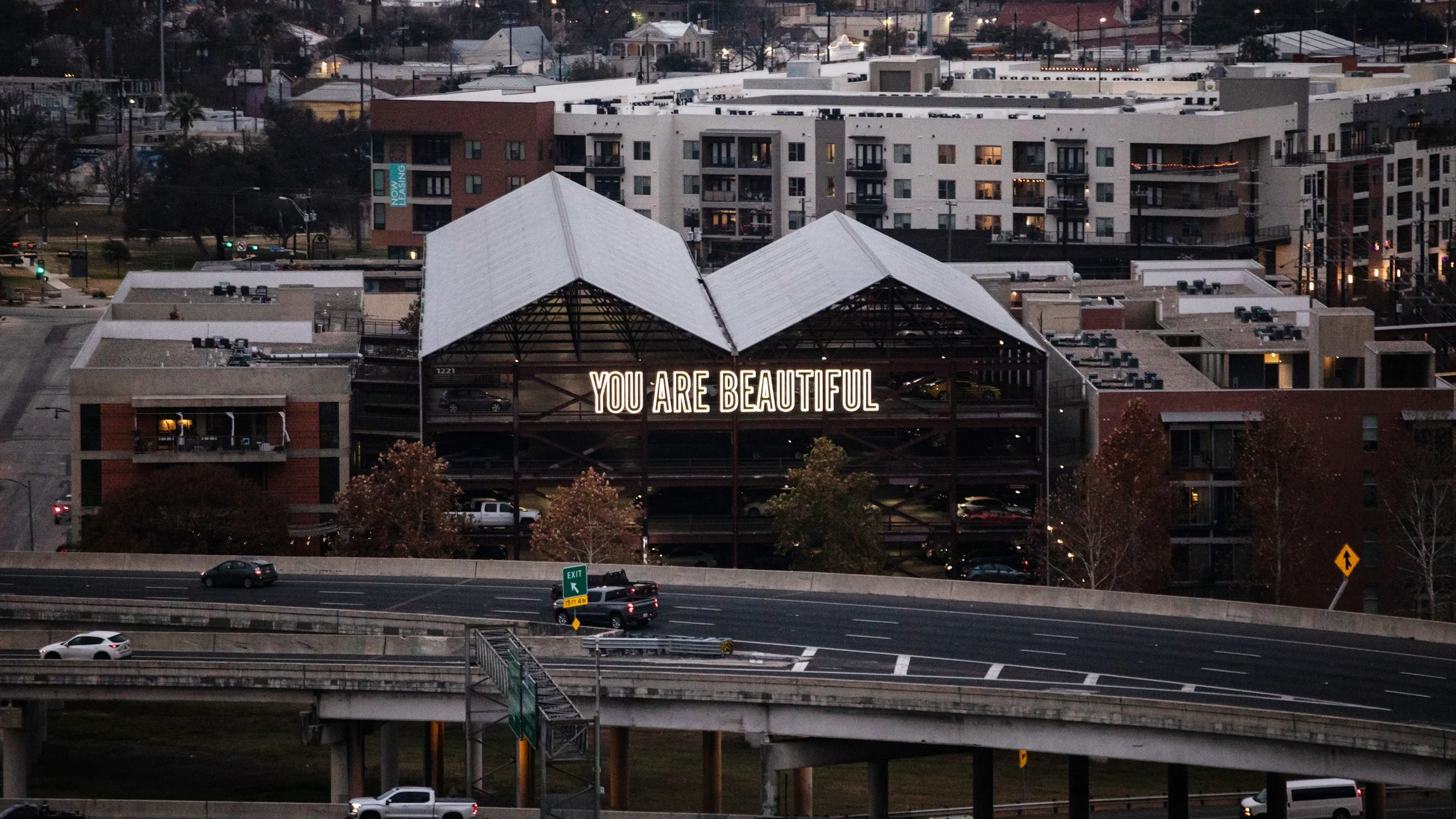 Matthew Hoffman large scale You Are Beautiful text installation on downtown San Antonio parking structure