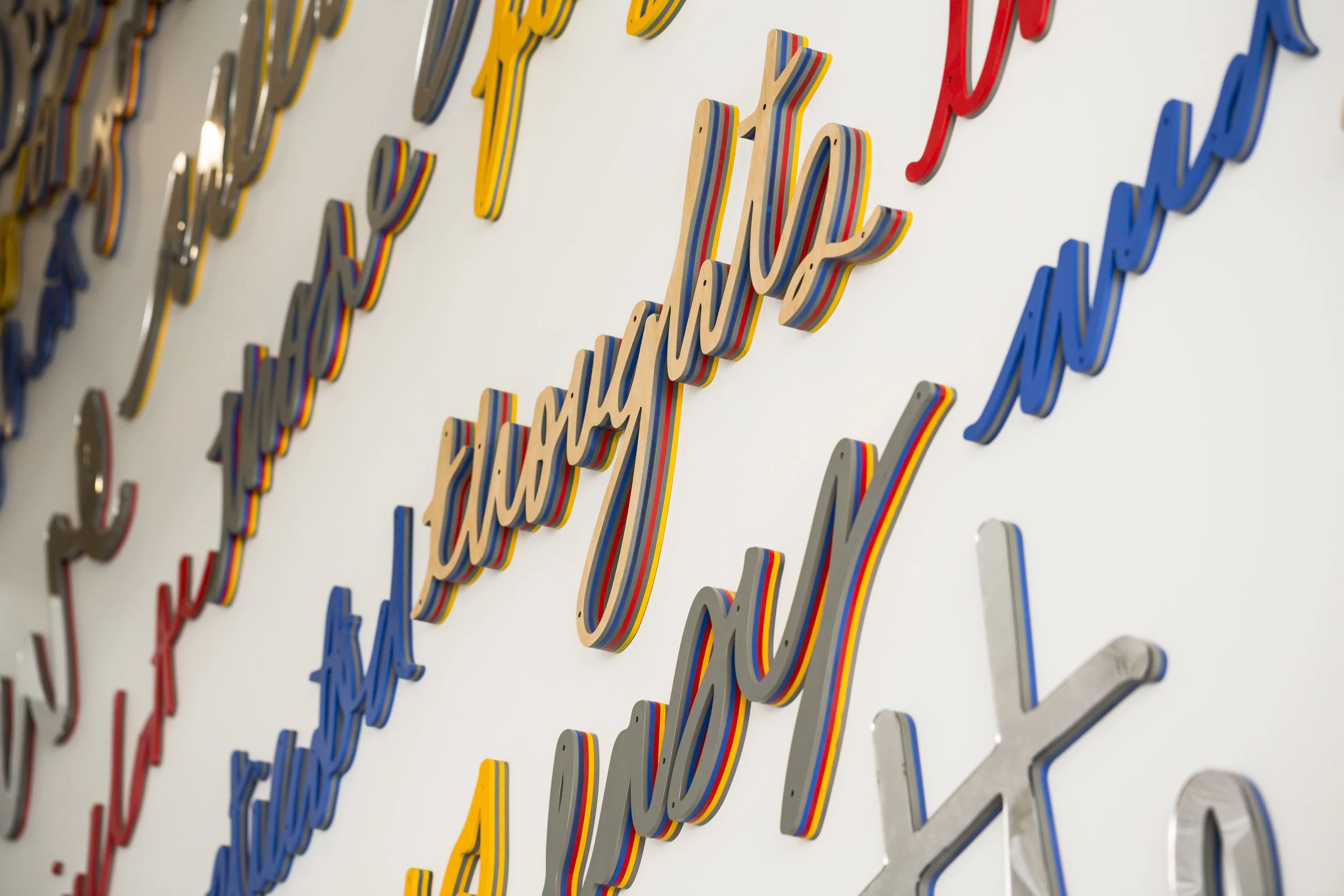 Colorful 3D word installation by Matthew Hoffman, “Spoke” lobby artwork in River West, Chicago apartment building.