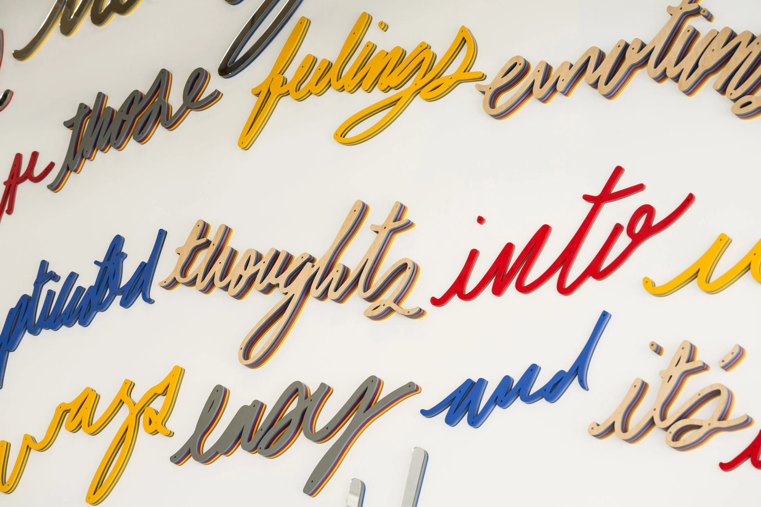 Colorful 3D word installation by Matthew Hoffman, “Spoke” lobby artwork in River West, Chicago apartment building.