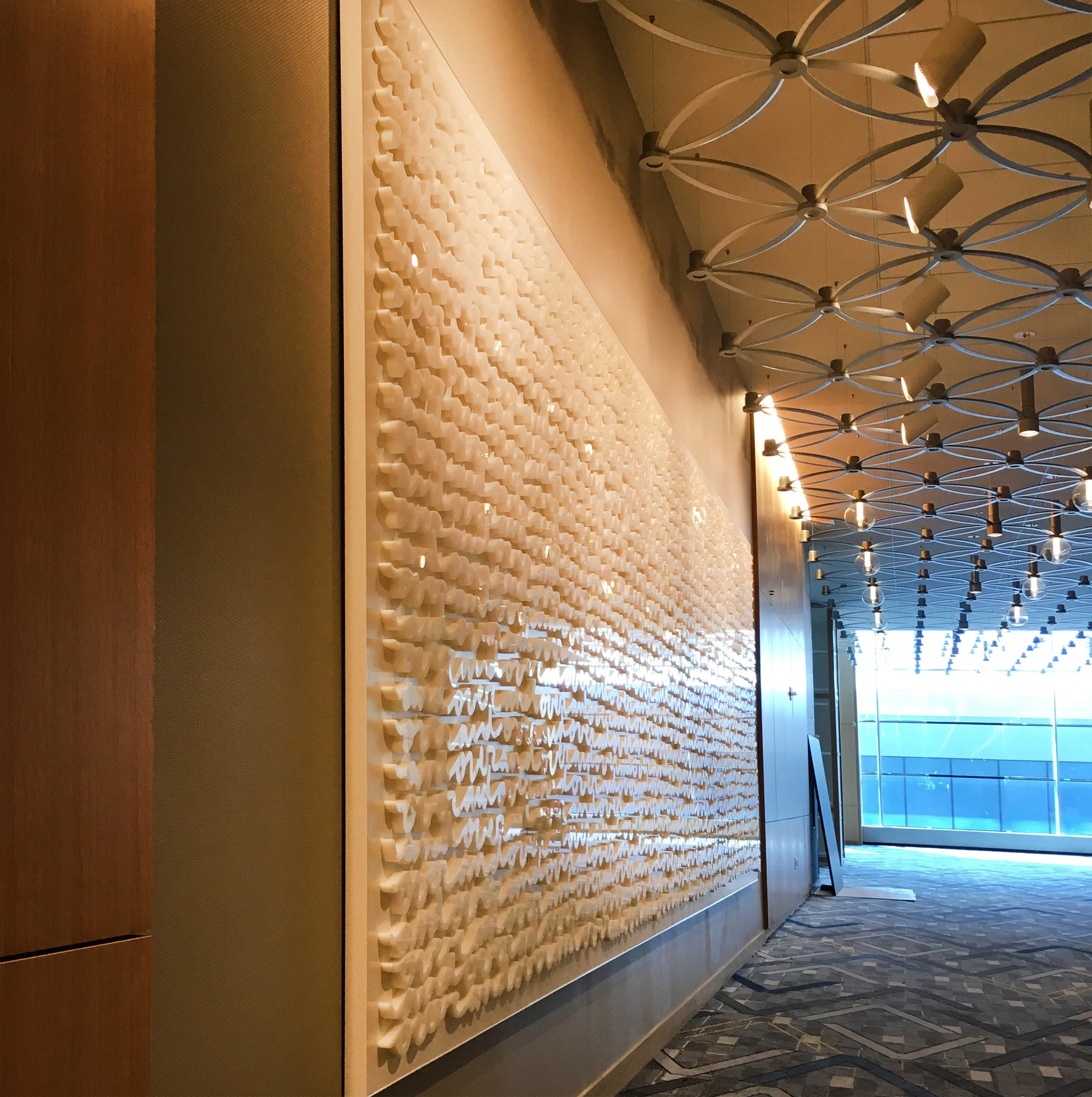 “Over & Over” large-scale white-on-white wall installation by Matthew Hoffman at Hyatt Regency McCormick Place, Chicago.