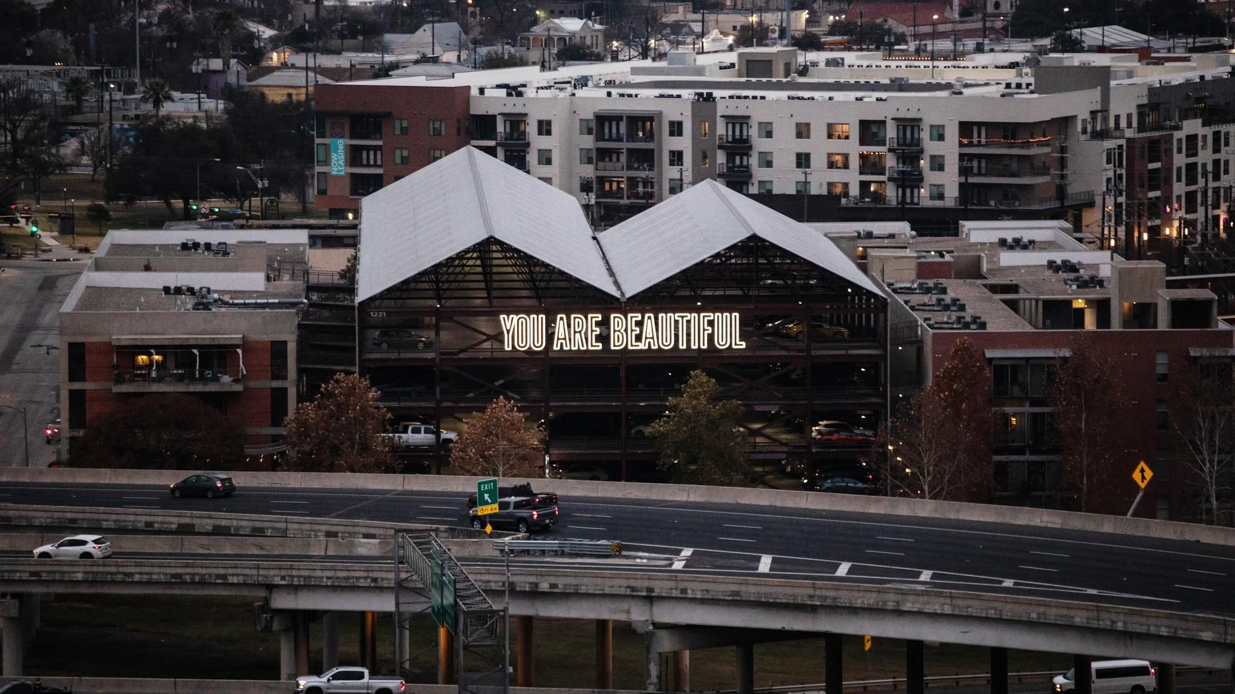 You Are Beautiful
San Antonio, Texas

Seen from Highway 281 and Interstate 35 as people move through the city each day.

Placed across the side of a downtown parking structure, the work becomes part of the urban landscape itself, experienced through 