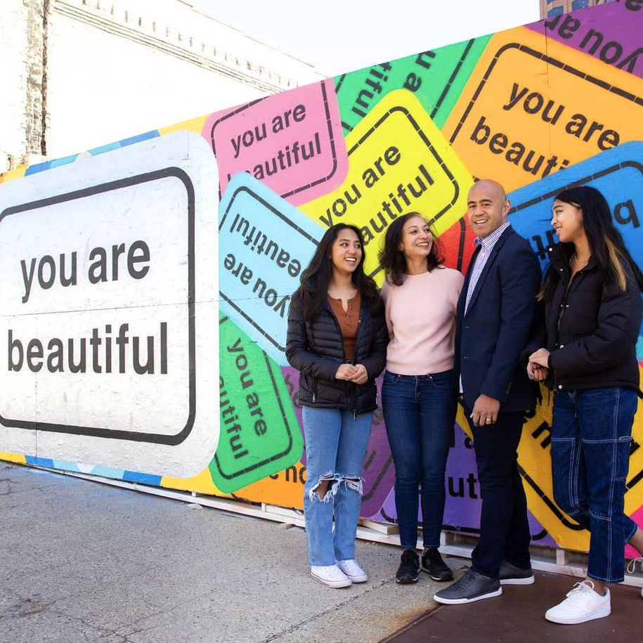 You Are Beautiful collage mural covering a temporary construction wall in downtown Milwaukee, Wisconsin.