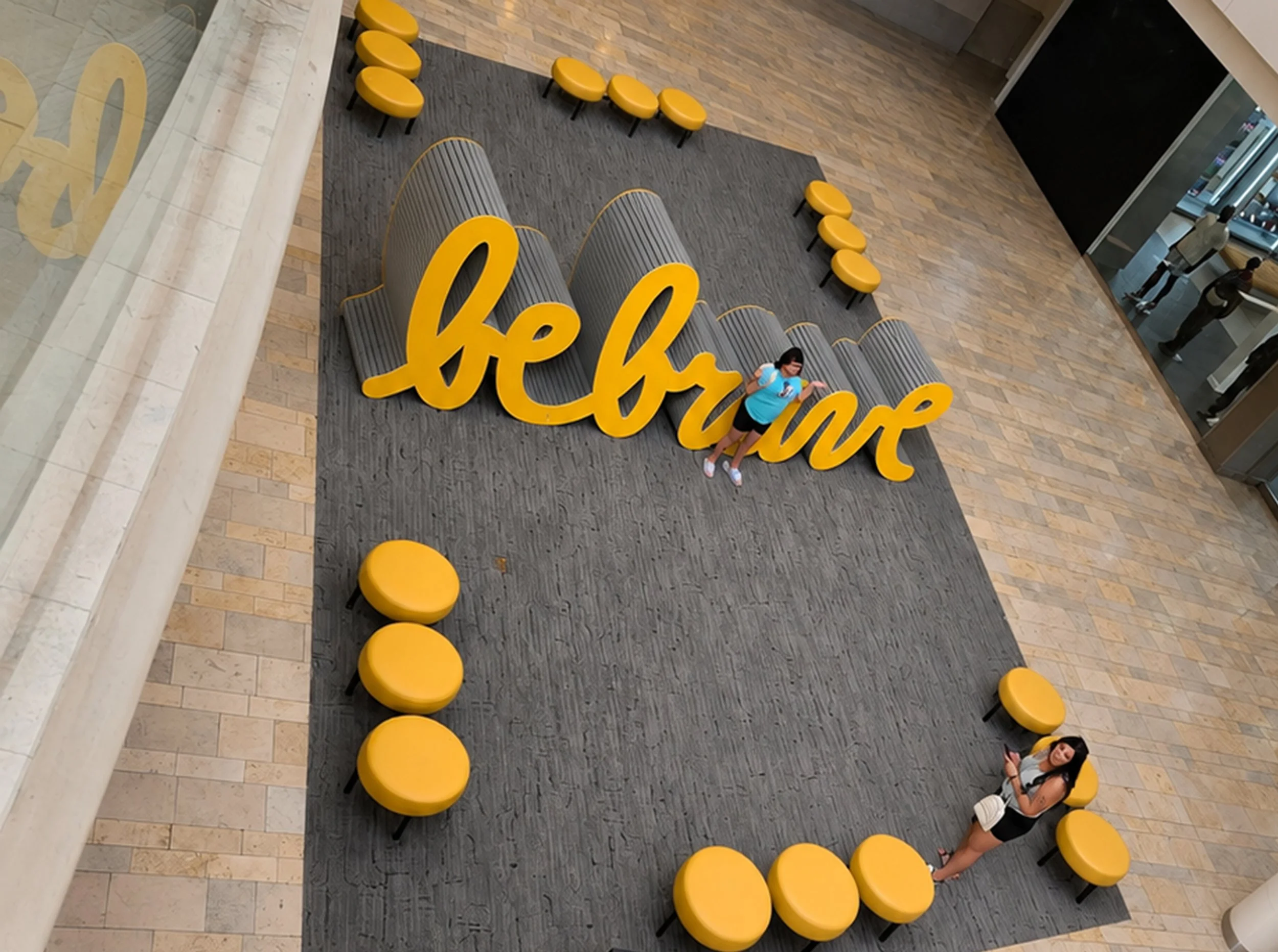 Large yellow Be Brave sculpture by Matthew Hoffman installed at Fashion Show Mall in Las Vegas, Nevada.