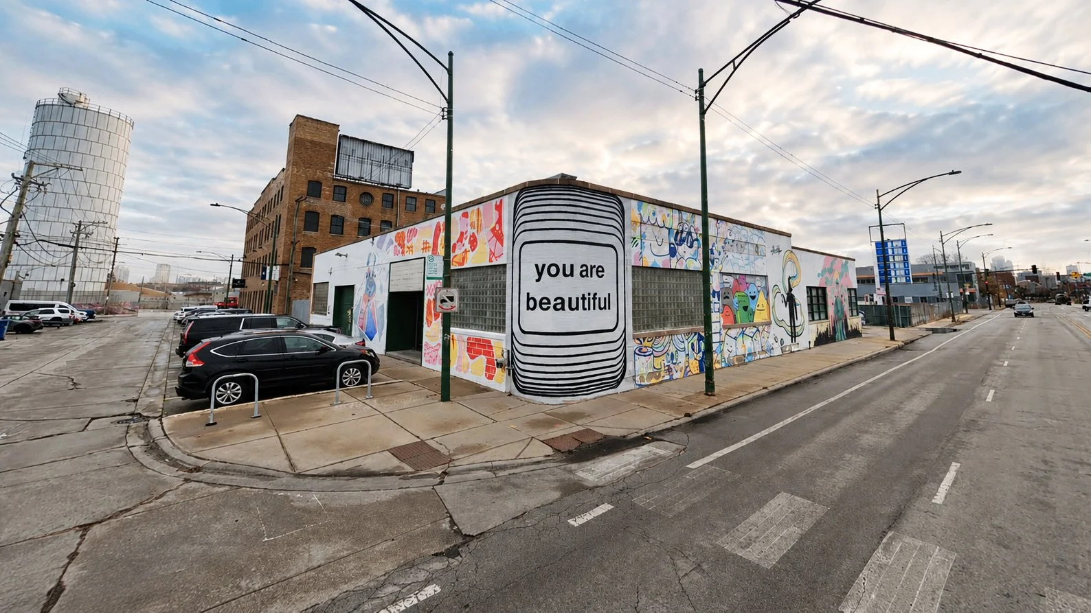 Matthew Hoffman You Are Beautiful Chicago mural wrapping curved architecture at street intersection