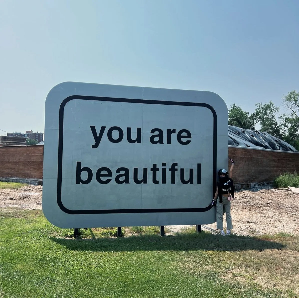 Close-up of the “You Are Beautiful” letters designed by Matthew Hoffman, glowing in the Chicago light, a message of hope for all who pass by.