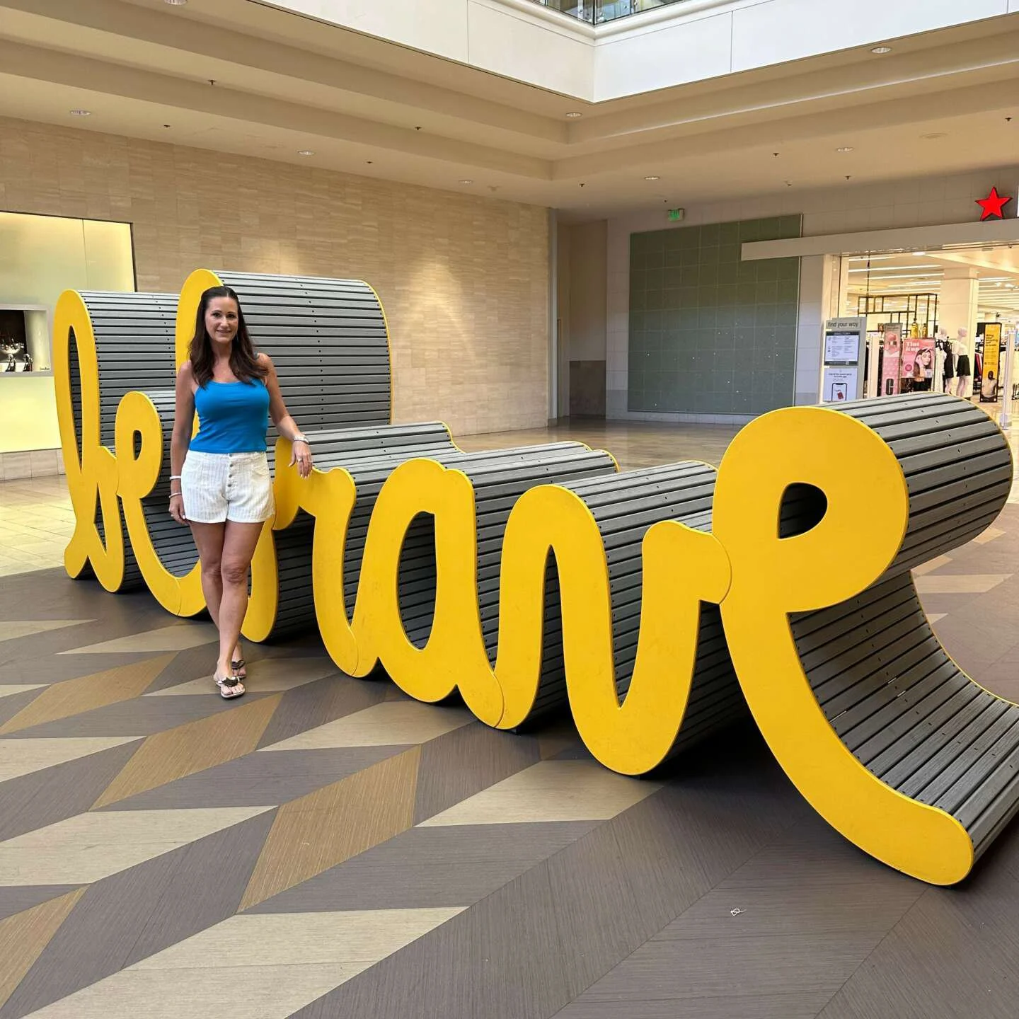 Visitor interacting with the Be Brave sculpture at Fashion Show Mall
