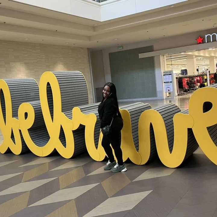 Visitor interacting with the Be Brave sculpture at Fashion Show Mall