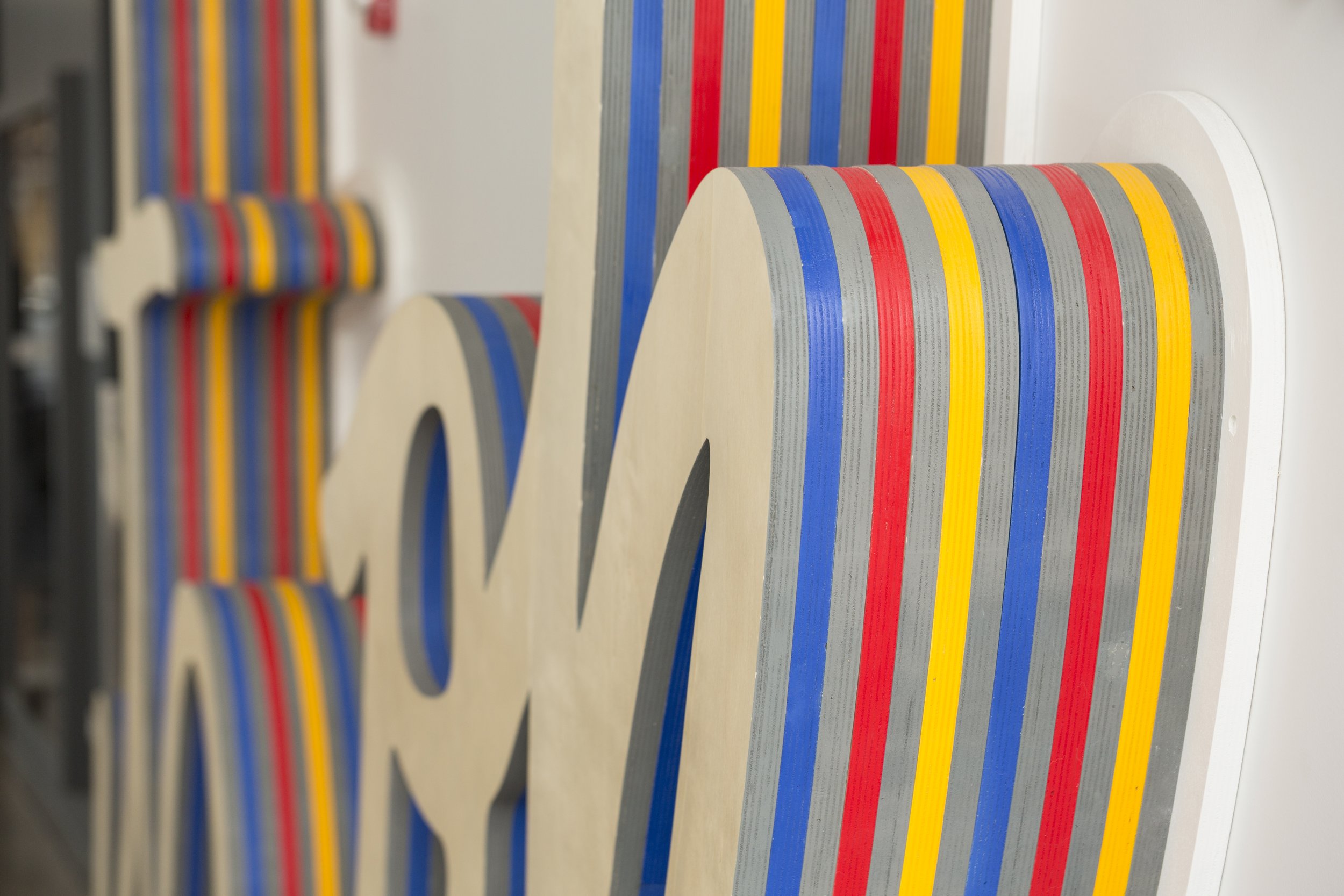     Two-story It’s OK installation by Matthew Hoffman inside Spoke Apartments in Chicago’s River West neighborhood.
