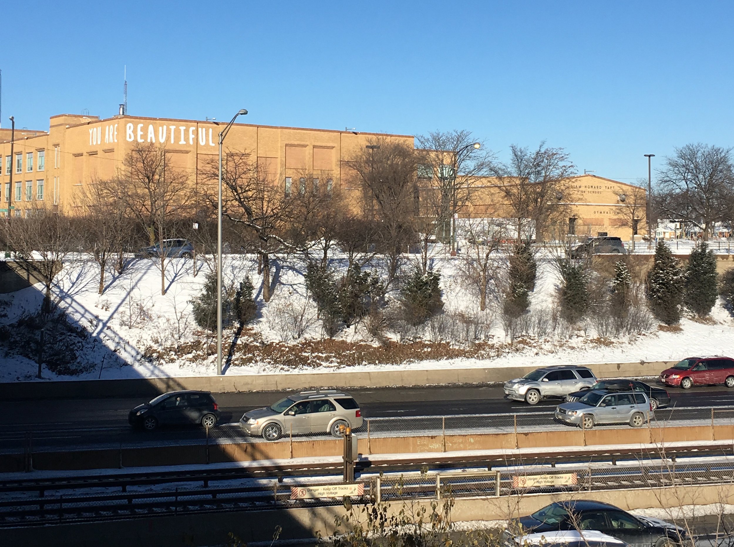 Matthew Hoffman You Are Beautiful Chicago school facade visible from highway public art