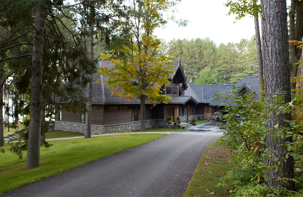 First seen from a distance, this Lindal Classic, wrapped with steep hip roofs and gabled dormers, rises boldly from its natural setting.