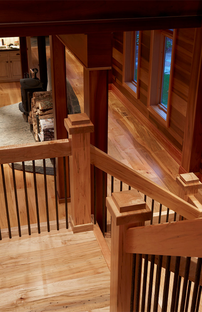 Open riser (species) stairs and rails with wrought iron balusters.