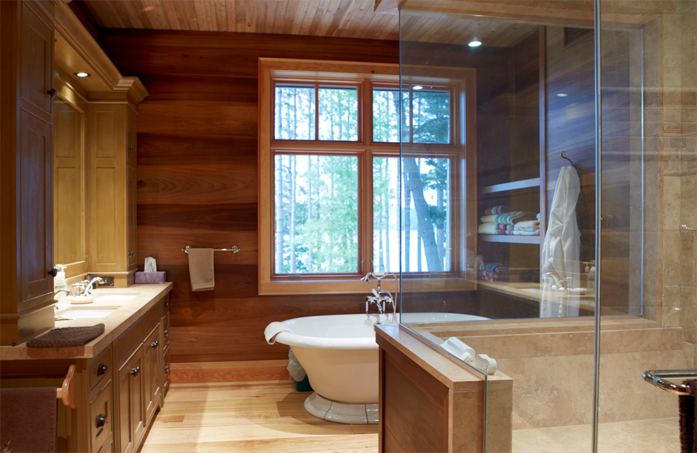   Even the naturally-lit master bath enjoys lakeside forested views …     