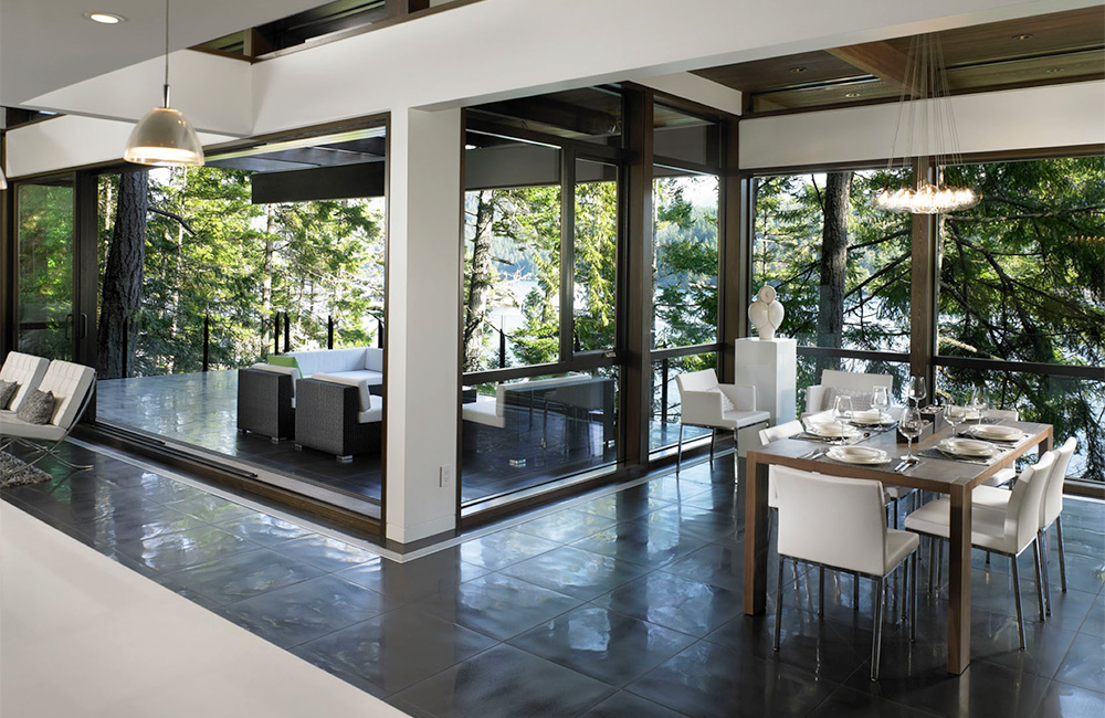   The use of wood on the interior of this Turkel Design home is reserved for the Lindal-produced minimally framed cedar windows that quiet literally frame every view and for the Lindal signature post and beam roof canopy made more subtle by its deep 