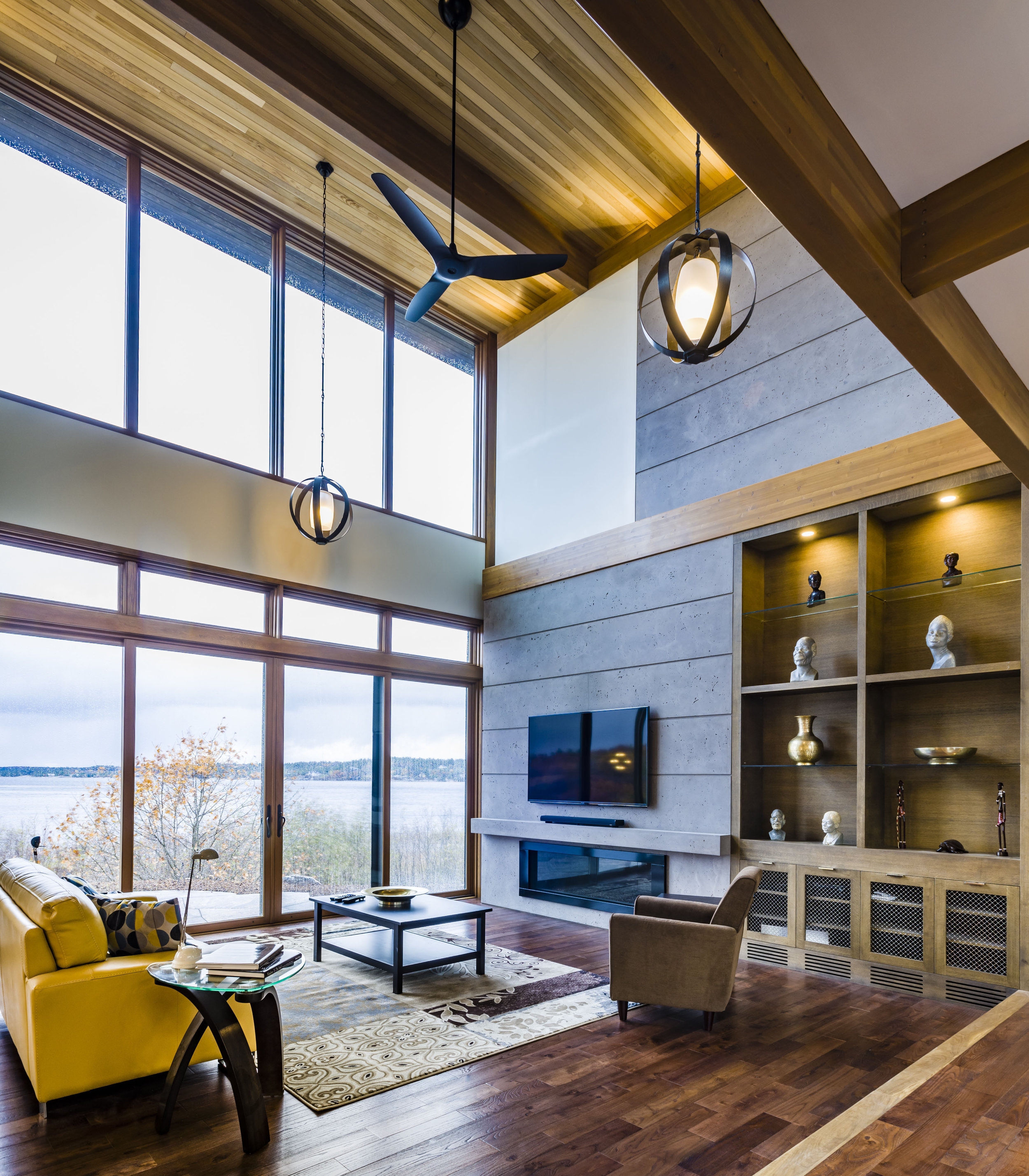 The sheetrock header over doors, trim band above the fireplace, and built-ins maintain the human scale in a 17-foot-high space.