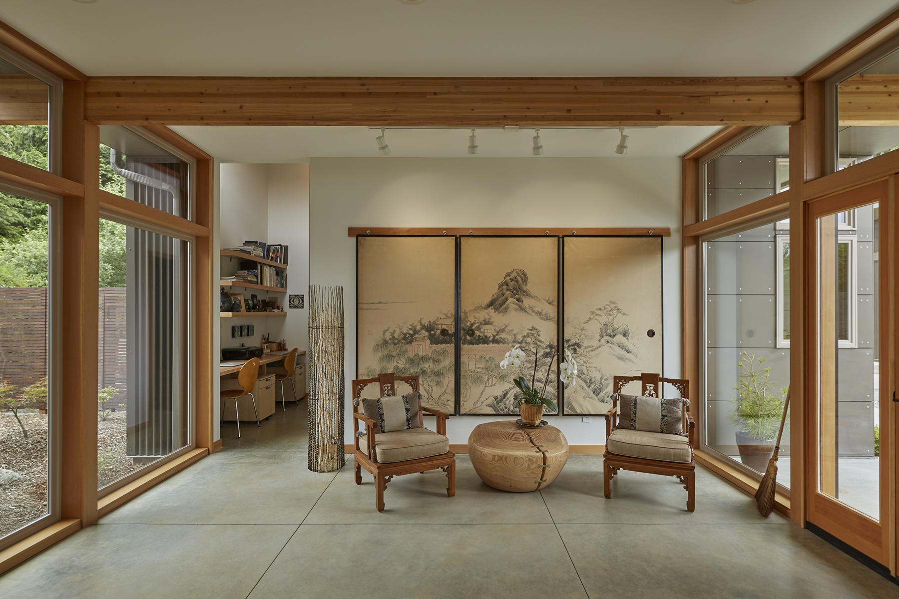 Transparent entry opens onto Japanese garden