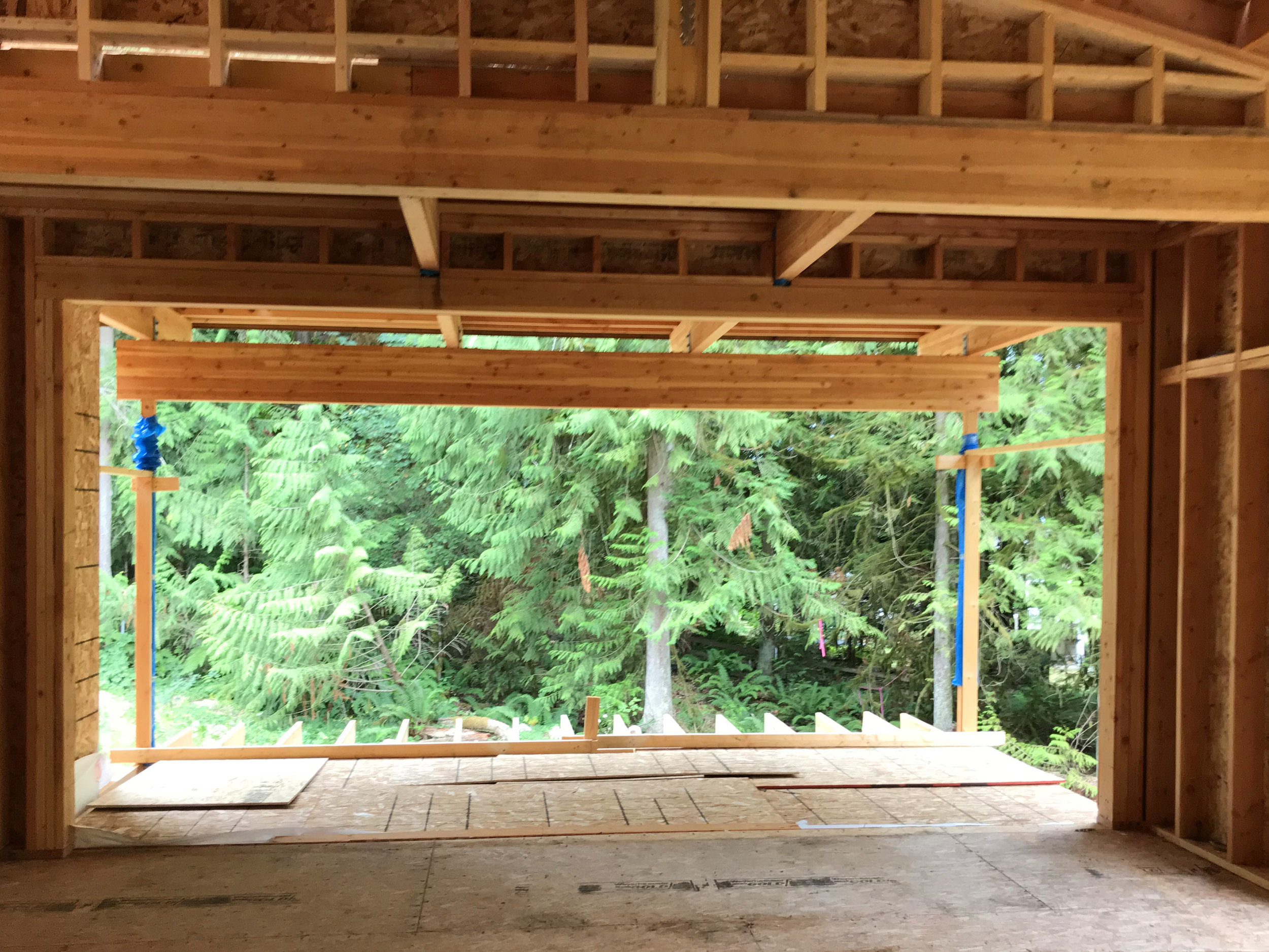   The beautiful and strong Lindal laminated Douglas fir beams make “easy lifting” of wide openings, here a series of 16’ openings… into the dining room, out onto the covered deck beyond, and at the outside corners of the deck. No additional support r